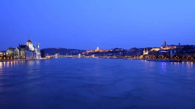 The Hungarian Parliament building and Buda Castle along the Danube in Budapest at dusk